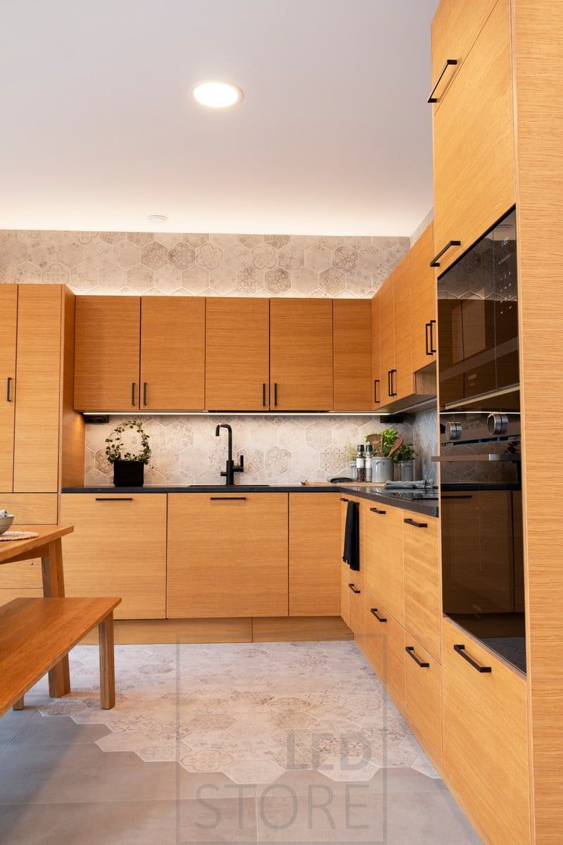 The kitchen is lit by ceiling plafonds and LED strip lights for indirect lighting and countertop lighting. Ledstore.fi